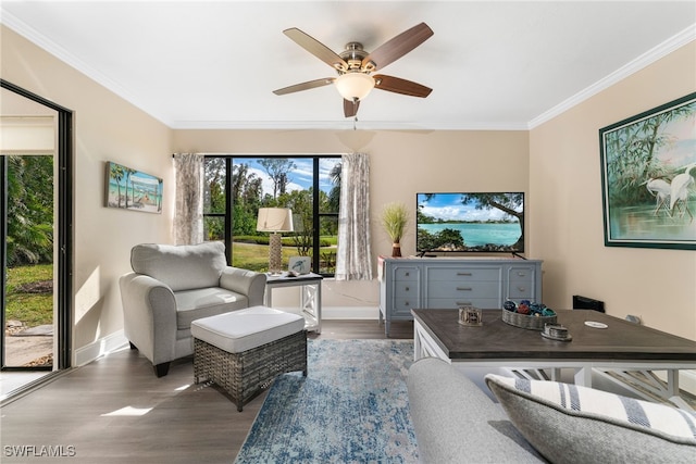 living room featuring crown molding, dark wood-type flooring, and ceiling fan