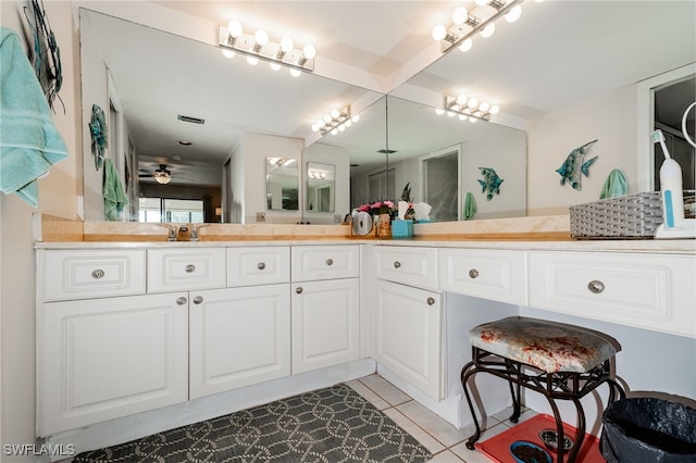 bathroom with tile patterned flooring, vanity, and ceiling fan