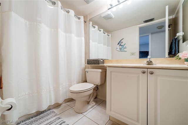 bathroom with tile patterned flooring, vanity, and toilet