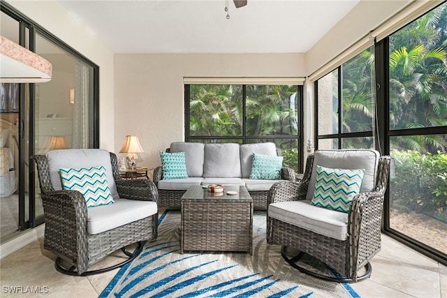 sunroom / solarium featuring ceiling fan