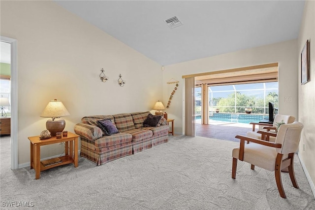 living room with carpet flooring and vaulted ceiling