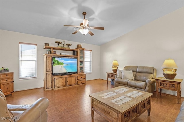 living room with light hardwood / wood-style flooring, ceiling fan, and plenty of natural light