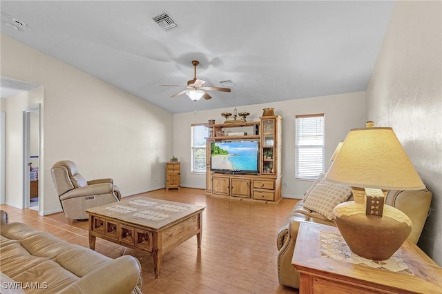 living room featuring lofted ceiling, light hardwood / wood-style flooring, and ceiling fan