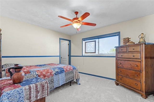 bedroom featuring light colored carpet and ceiling fan