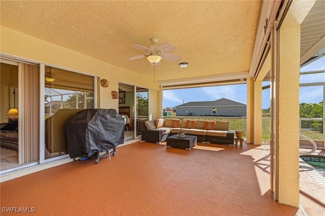 view of patio / terrace featuring an outdoor living space, area for grilling, and glass enclosure