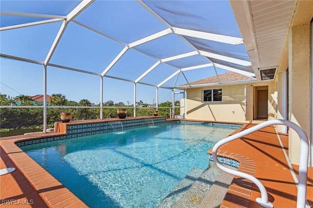 view of swimming pool with pool water feature and glass enclosure