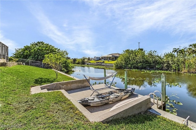 view of dock featuring a water view and a yard