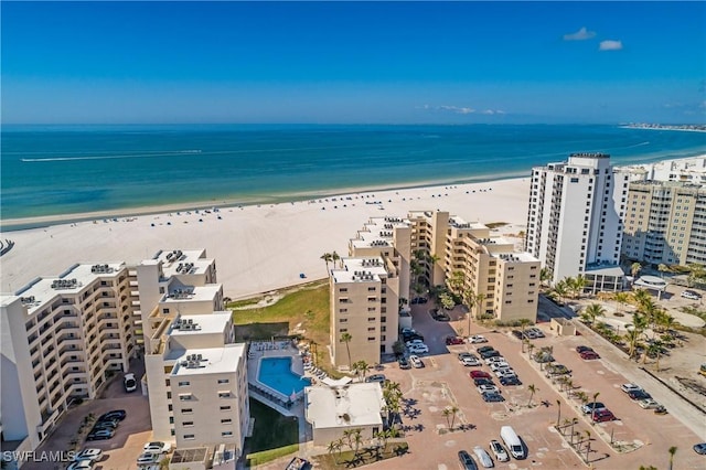 drone / aerial view with a water view and a beach view