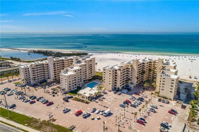 drone / aerial view featuring a water view and a beach view