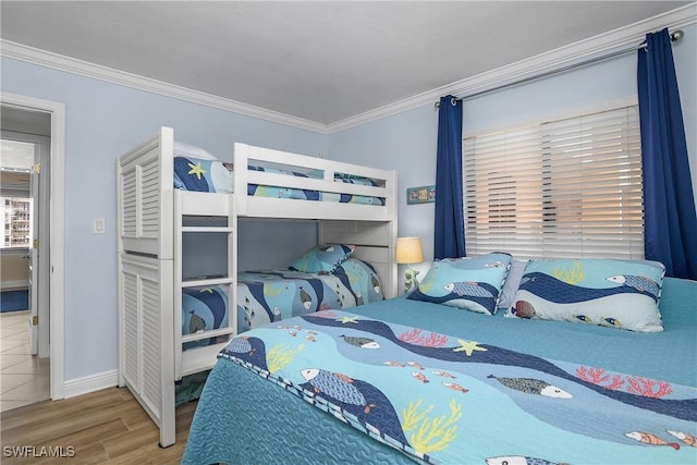 bedroom with ornamental molding and wood-type flooring