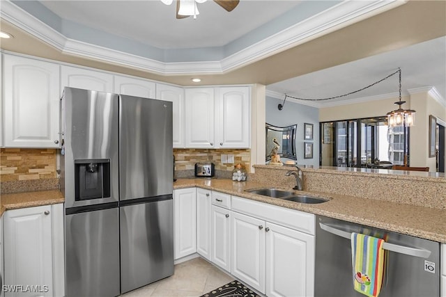 kitchen with white cabinetry, appliances with stainless steel finishes, sink, and crown molding