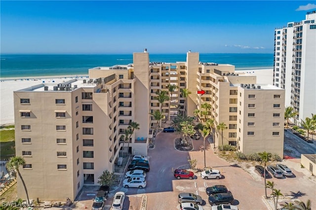 view of property with a view of the beach and a water view