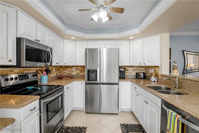 kitchen featuring light stone countertops, stainless steel appliances, and white cabinets