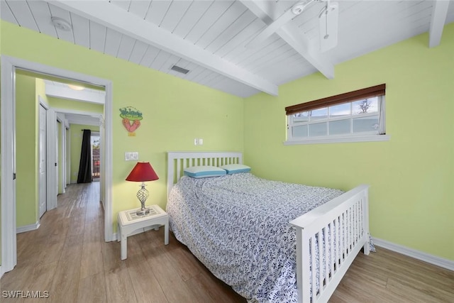 bedroom with hardwood / wood-style flooring, wood ceiling, and beam ceiling