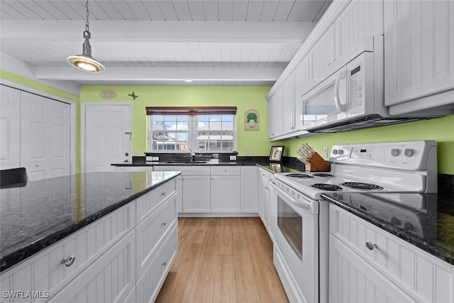 kitchen with sink, white appliances, white cabinetry, decorative light fixtures, and dark stone counters