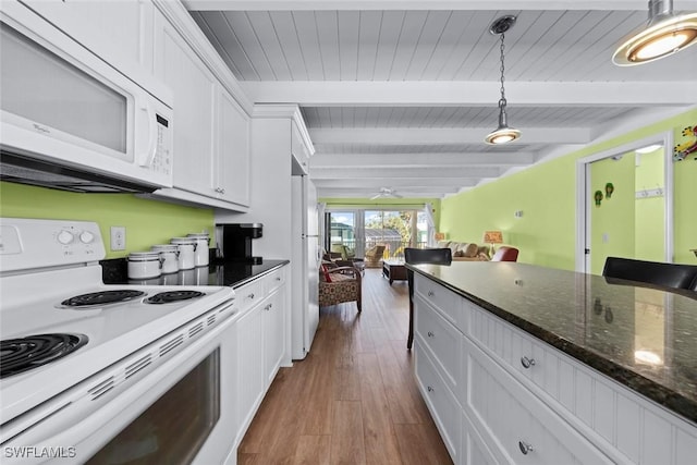 kitchen featuring hanging light fixtures, white appliances, dark wood-type flooring, and white cabinets