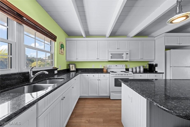 kitchen with pendant lighting, sink, white appliances, beam ceiling, and white cabinets