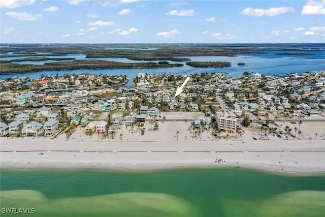 drone / aerial view with a water view and a view of the beach