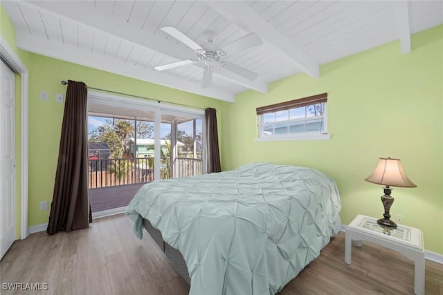 bedroom featuring wood ceiling, access to exterior, beam ceiling, and light hardwood / wood-style flooring