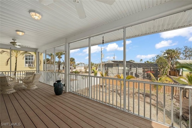 deck featuring ceiling fan and a lanai