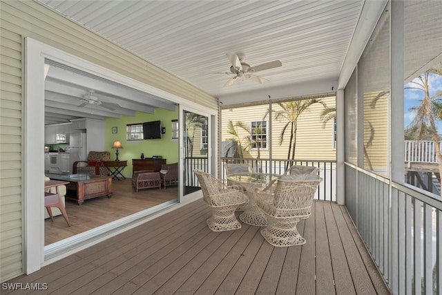 sunroom / solarium with ceiling fan and a healthy amount of sunlight