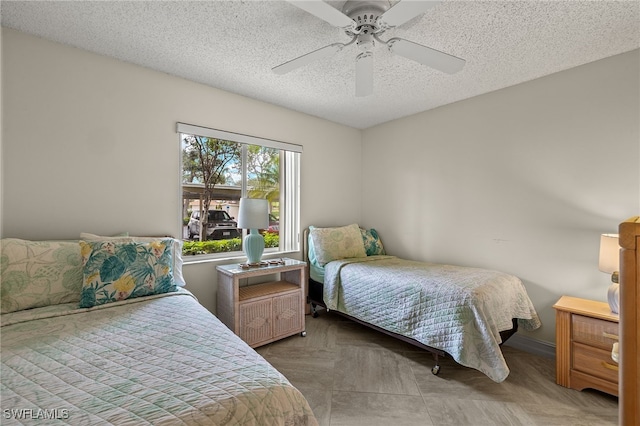 bedroom featuring a textured ceiling and ceiling fan