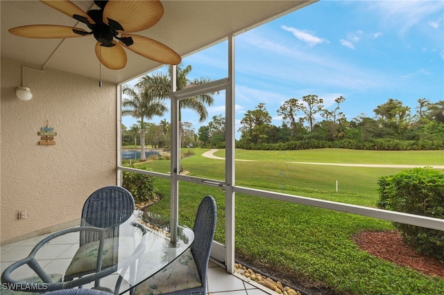 7025 Dennis Cir Unit G104, Naples, FL 34104 - sunroom featuring view of golf course, a ceiling fan, and view of scattered trees