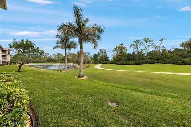 surrounding community featuring a lawn and a water view