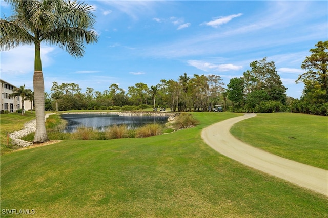 view of home's community featuring a water view and a lawn