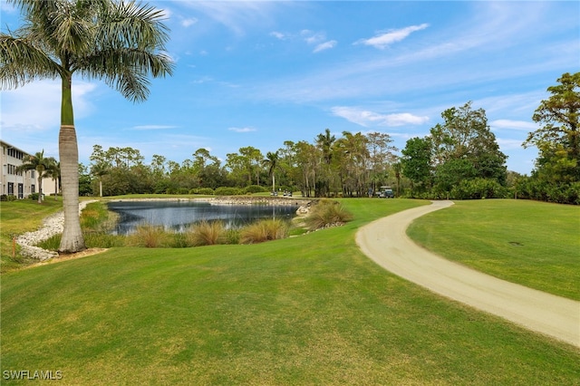 7025 Dennis Cir Unit G104, Naples, FL 34104 - view of community featuring a water view, a yard, golf course view, and view of wooded area