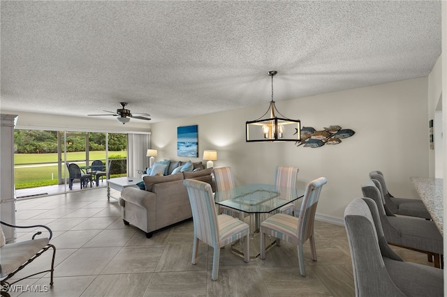 tiled dining area with ceiling fan with notable chandelier