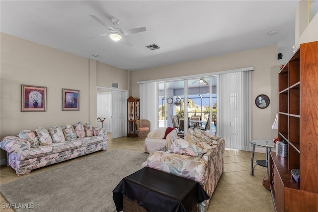 living room featuring light tile patterned floors and ceiling fan