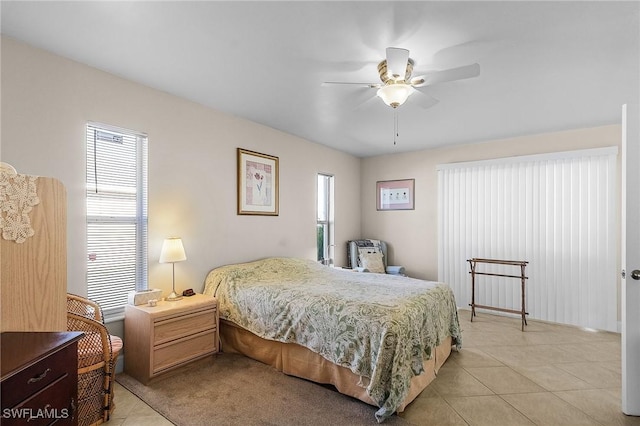 bedroom featuring light tile patterned flooring and ceiling fan