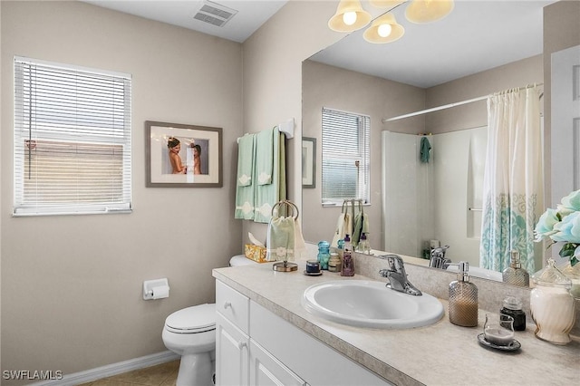 bathroom featuring a shower with curtain, vanity, toilet, and tile patterned flooring