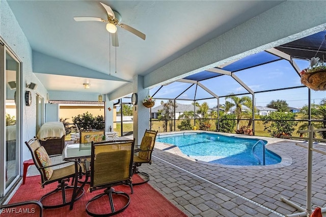 view of pool with ceiling fan, a lanai, and a patio area