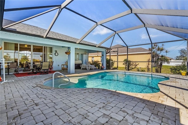 view of swimming pool with a lanai and a patio