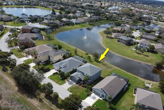 drone / aerial view featuring a residential view and a water view