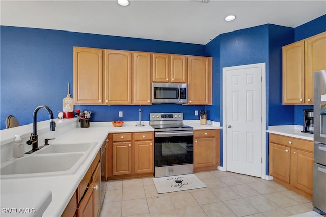 13380 Hampton Park Ct, Fort Myers, FL 33913 - kitchen featuring appliances with stainless steel finishes, a sink, light countertops, light brown cabinets, and light tile patterned flooring