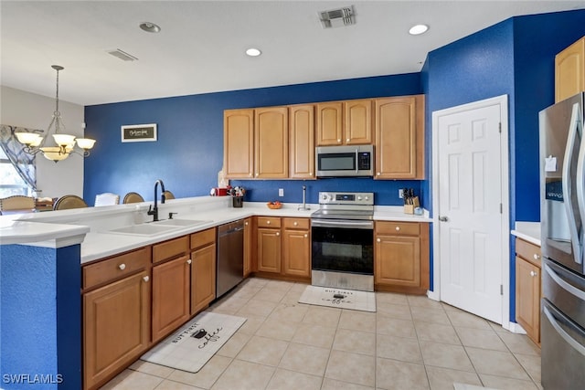 13380 Hampton Park Ct, Fort Myers, FL 33913 - kitchen featuring stainless steel appliances, a sink, a chandelier, a peninsula, and light countertops