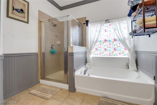 13380 Hampton Park Ct, Fort Myers, FL 33913 - full bathroom with a stall shower, a bath, tile patterned floors, and a wainscoted wall