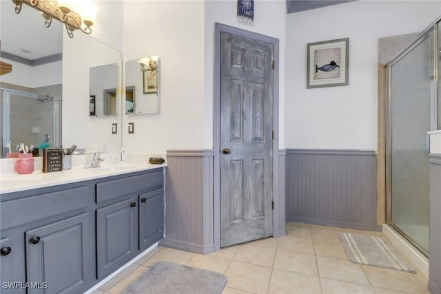 13380 Hampton Park Ct, Fort Myers, FL 33913 - full bath with wainscoting, a shower stall, double vanity, and tile patterned flooring