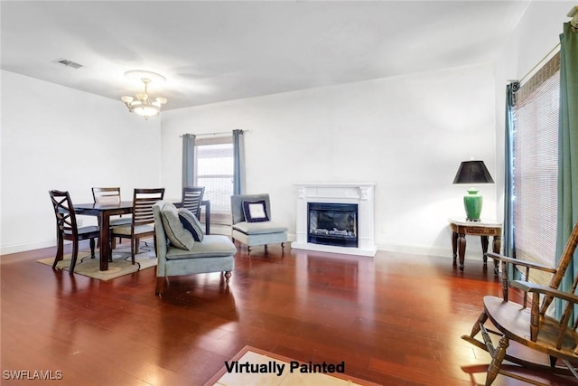 13380 Hampton Park Ct, Fort Myers, FL 33913 - living area featuring a chandelier, wood finished floors, a glass covered fireplace, and baseboards