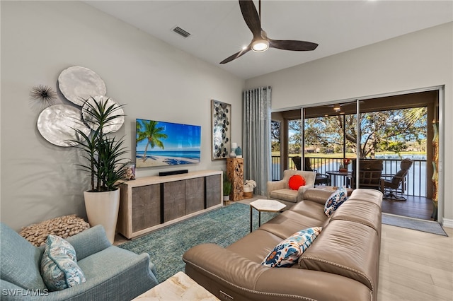 living room featuring ceiling fan and light hardwood / wood-style floors