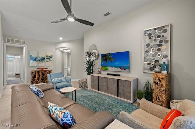 living room with light hardwood / wood-style floors and ceiling fan