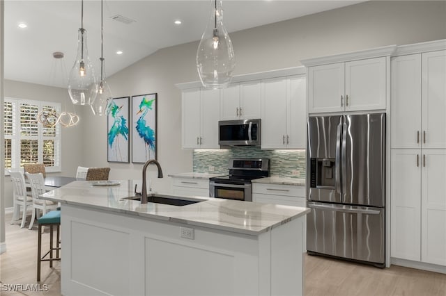 kitchen with white cabinets, a spacious island, and appliances with stainless steel finishes