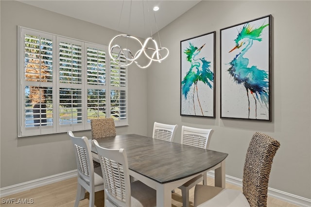 dining area featuring an inviting chandelier and light hardwood / wood-style floors