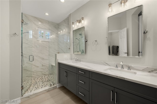 bathroom featuring walk in shower, vanity, and hardwood / wood-style flooring