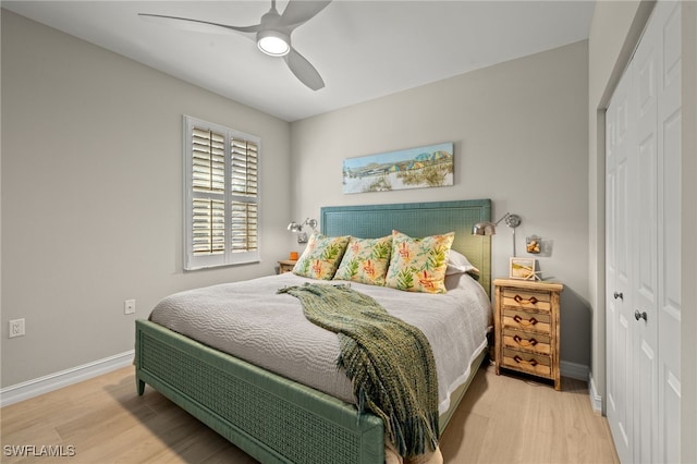 bedroom with ceiling fan, a closet, and light hardwood / wood-style flooring