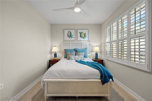 bedroom featuring hardwood / wood-style flooring and ceiling fan