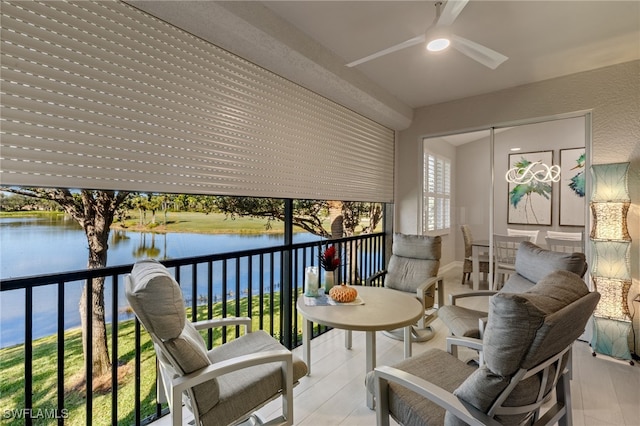 balcony with a water view and ceiling fan